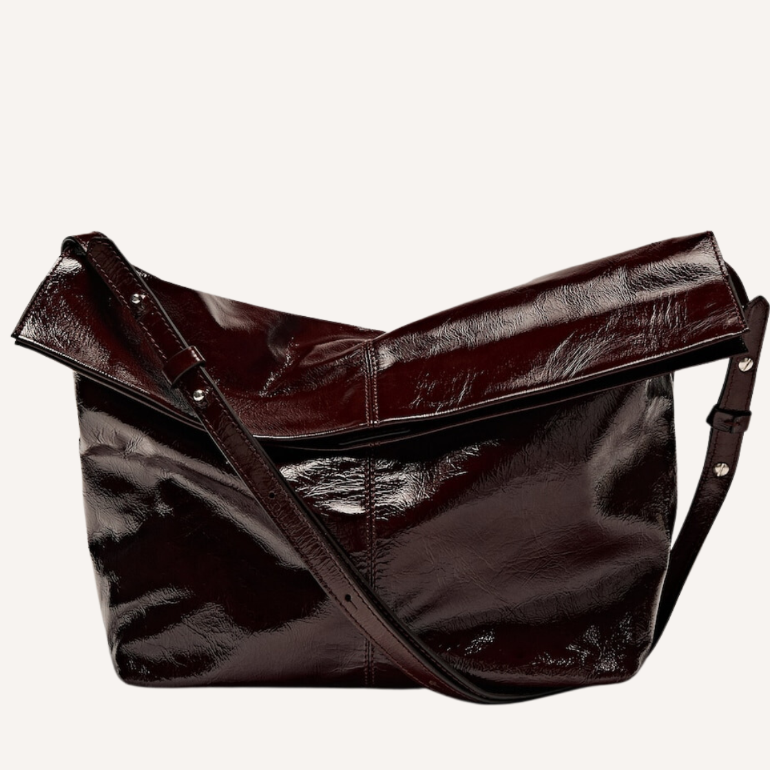 As the crisp air of fall settles in, nothing completes a seasonal wardrobe like chic burgundy bags.