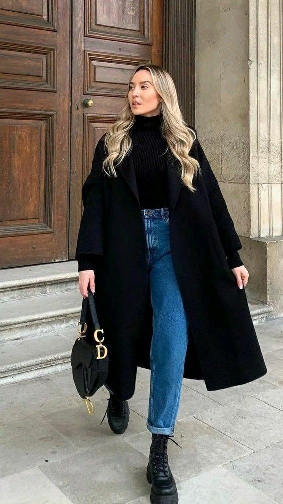 Freya Killin outfit with blue jeans, black boots, turtleneck sweater,dior bag. and black coat