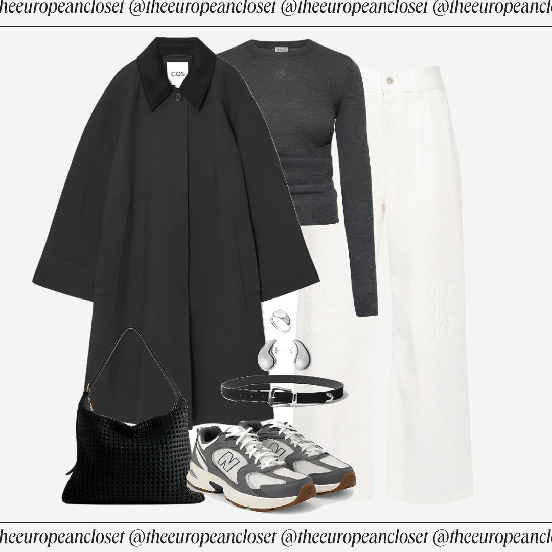 Flat lay of a black COS wool coat with a distinctive collar, a fitted dark gray top, and white wide-leg pants with subtle detailing, accessorized with gray and white New Balance sneakers, a black woven shoulder bag, and a silver and black belt with a unique buckle. Text overlay reads "theeuropeancloset" and "COS".