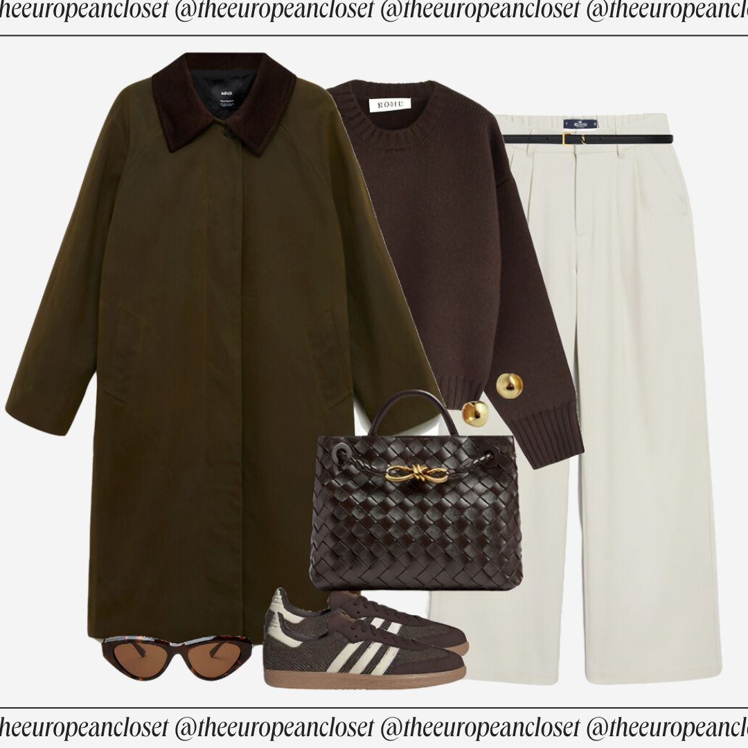 Flat lay of a green trench coat with a brown velvet collar and button closure, a brown crew neck sweater with ribbed cuffs and gold button embellishments on the shoulder, and white wide-leg trousers with a visible weave texture, accessorized with Adidas Samba sneakers, a woven leather tote bag with gold hardware, and tortoiseshell sunglasses.